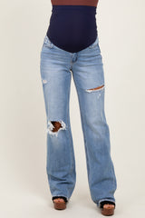 woman wearing light blue distressed maternity jeans with a dark blue belly panel