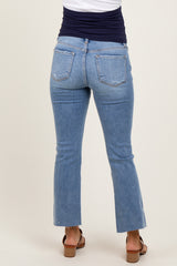 woman wearing light blue maternity jeans with a fitted waist and flared hems, seen from the back