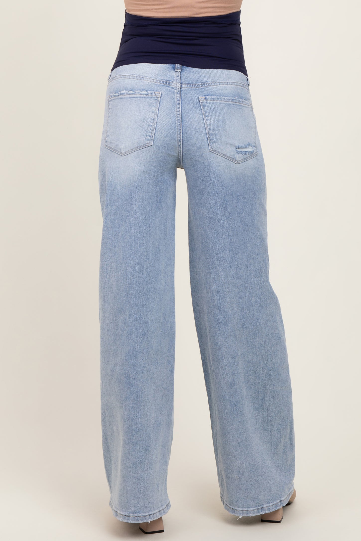 maternity wear light blue wide-leg jeans with a stretchy waistband, seen from the back