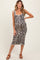 woman wearing a beige leopard print maternity dress with a fitted silhouette and a baby bump visible