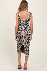 woman wearing a leopard print maternity dress with a back slit and fitted silhouette