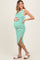 woman wearing a green and white striped maternity dress with a side slit and a visible baby bump