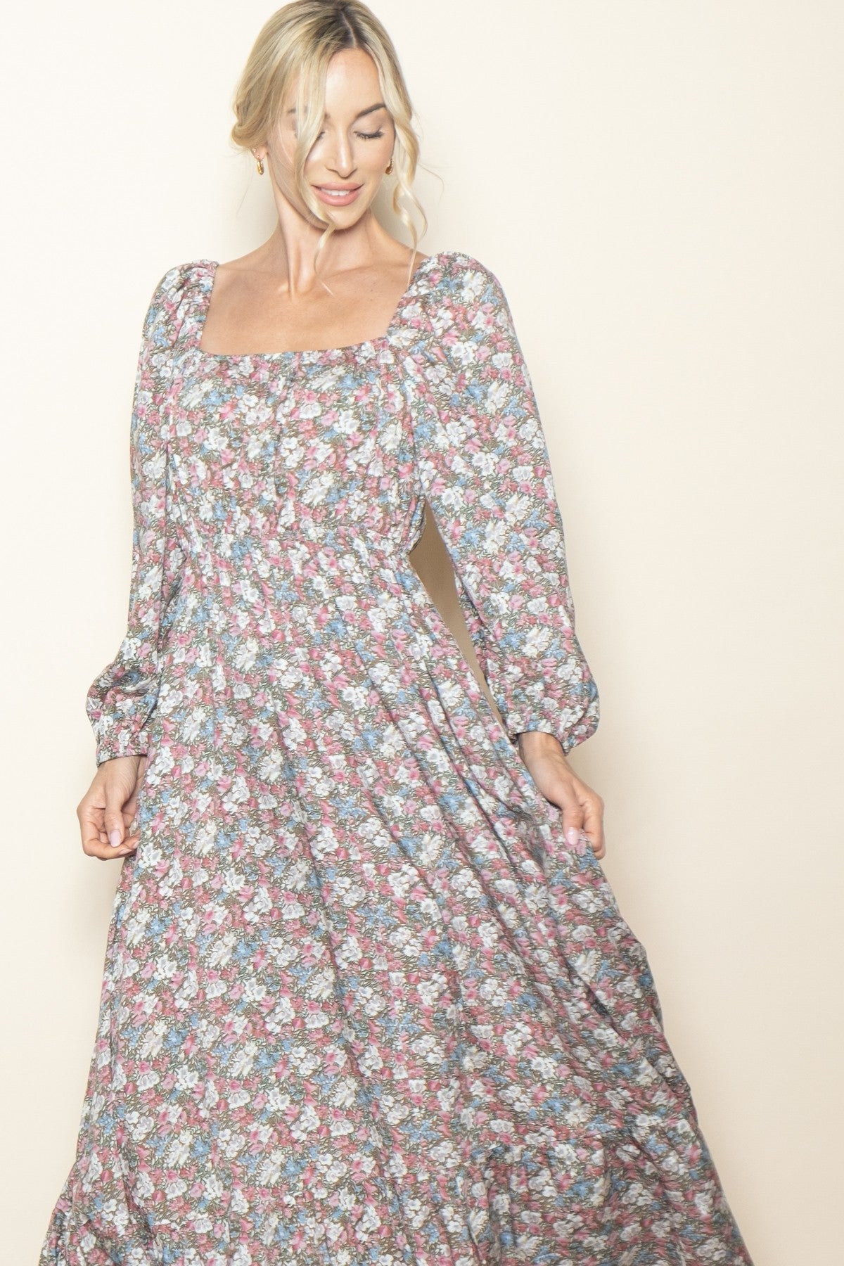 woman wearing a floral long maxi dress with a square neckline and puff sleeves
