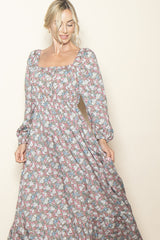 woman wearing a floral long maxi dress with a square neckline and puff sleeves