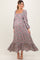 woman wearing a floral long sleeve maternity maxi dress with a square neckline and ruffled hem, showcasing her baby bump