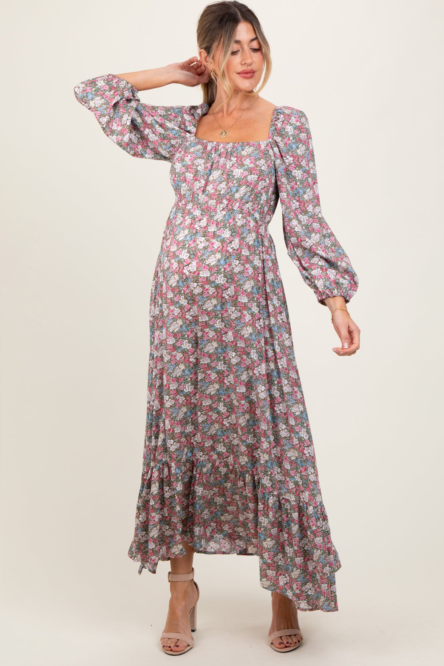 woman wearing a floral maternity maxi dress with puff sleeves and a square neckline, showcasing her baby bump