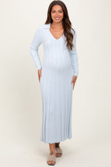 woman wearing a light blue ribbed maternity dress with a v-neck and long sleeves, showcasing her baby bump