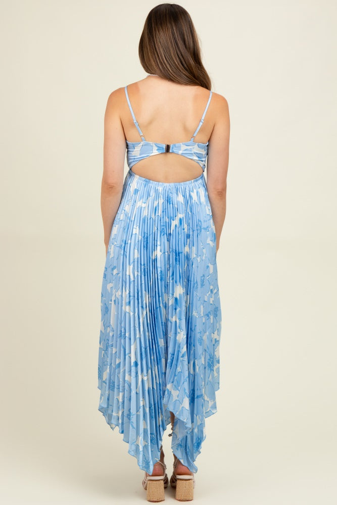 woman wearing a light blue maternity maxi dress with pleated details and a back cutout, showing off a baby bump