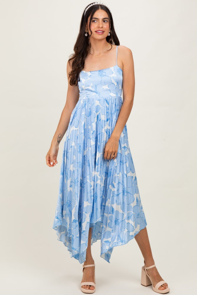 woman wearing a light blue floral maxi dress with a pleated skirt and spaghetti straps