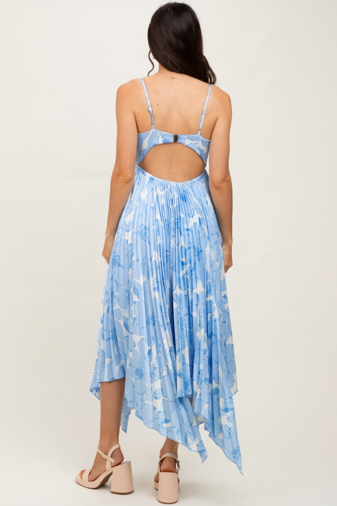 woman wearing a light blue pleated dress with a back cutout and high-low hemline