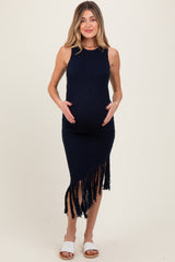 woman wearing a navy blue fringe maternity dress, showing her baby bump while standing confidently