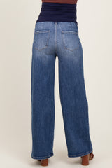 woman wearing a pair of blue wide-leg maternity jeans, showing the back view and a comfortable fit