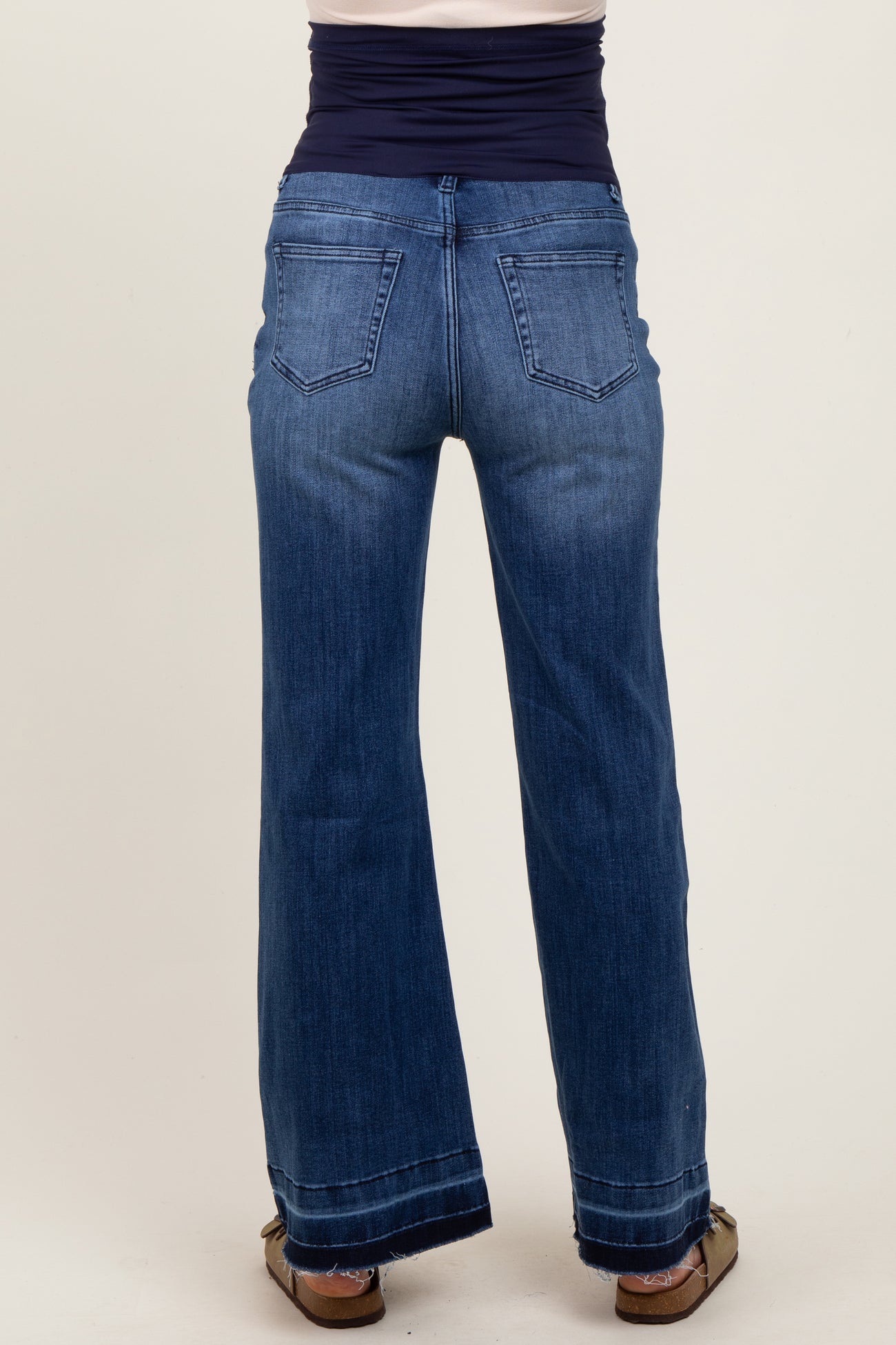 maternity wear blue wide leg jeans with a high waist and a stretchy panel at the top, shown from the back