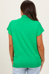 woman wearing a bright green short sleeve maternity top, showing the back view