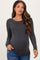woman wearing a dark grey ribbed long sleeve maternity top and showing her baby bump