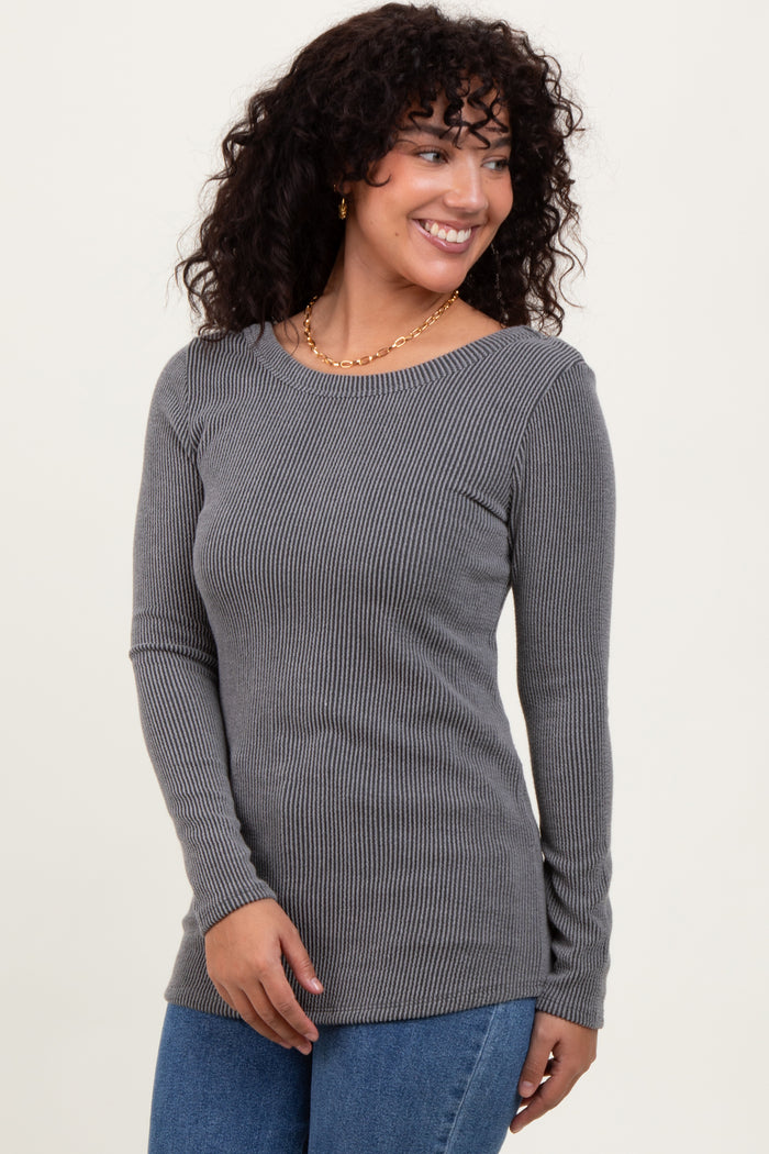 woman wearing a gray long sleeve ribbed top with a round neckline and smiling