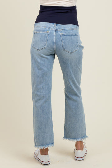 woman wearing light blue maternity jeans with a frayed hem, showing the back view, ideal for comfort during pregnancy