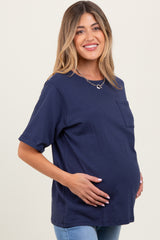 woman wearing a navy blue maternity t-shirt with a pocket and holding her baby bump