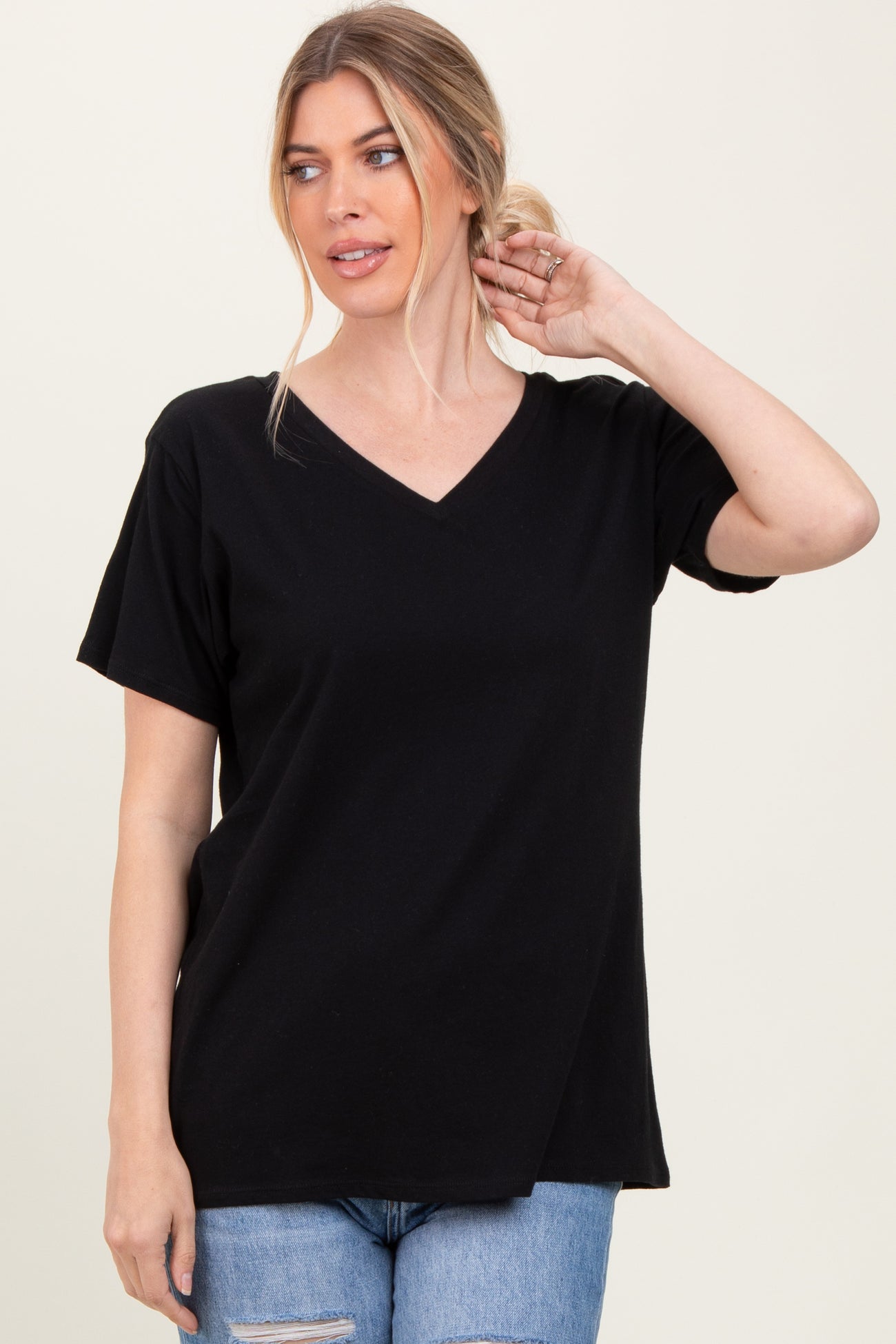 woman wearing a black short sleeve v-neck t-shirt with a relaxed fit and casual style