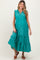 woman wearing a teal maternity maxi dress with ruffle details and a tied neckline, showing her baby bump