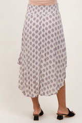 woman wearing a printed asymmetrical maternity skirt with a flowy design and a comfortable waistband