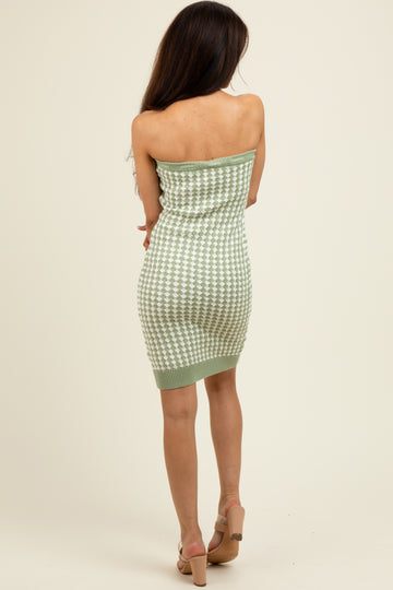 woman wearing a green and white checkered strapless knitted mini dress with a fitted silhouette