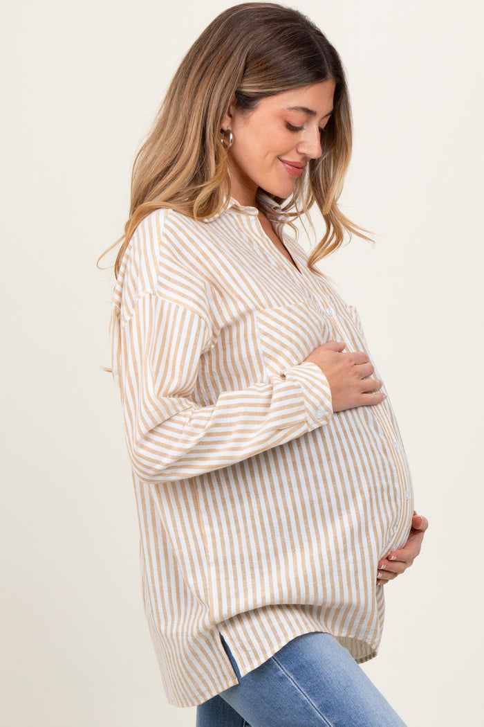 woman wearing a striped beige and white maternity top with a visible baby bump