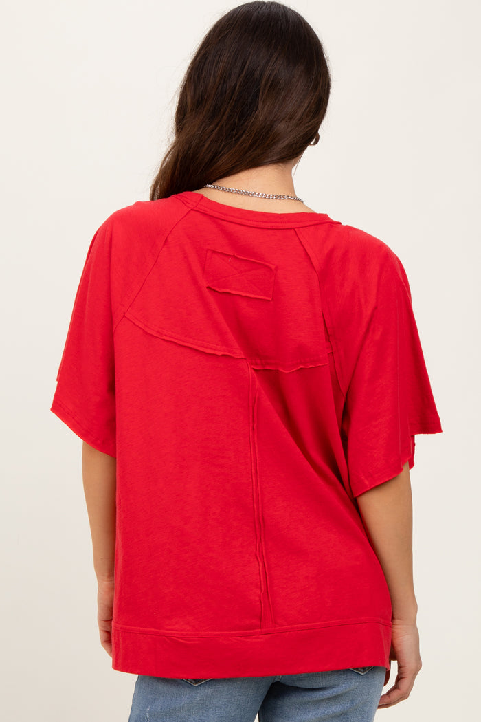 woman wearing a red oversized short sleeve t-shirt with back seam detail and casual style