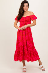 woman wearing a pink off-the-shoulder floral maxi dress with smocked bodice and ruffled hem