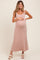 woman wearing a pink and white striped maternity maxi dress and holding her baby bump