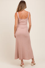 woman wearing a pink striped maternity maxi dress, showing the back view and a relaxed fit