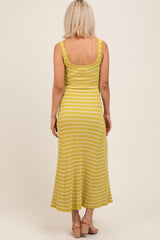 woman wearing a yellow striped maternity maxi dress, showing the back view with a fitted bodice and flared skirt