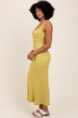 woman wearing a yellow striped maxi dress with spaghetti straps and a fitted silhouette