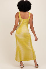 woman wearing a yellow striped maxi dress with a fitted bodice and sleeveless design, showing the back view