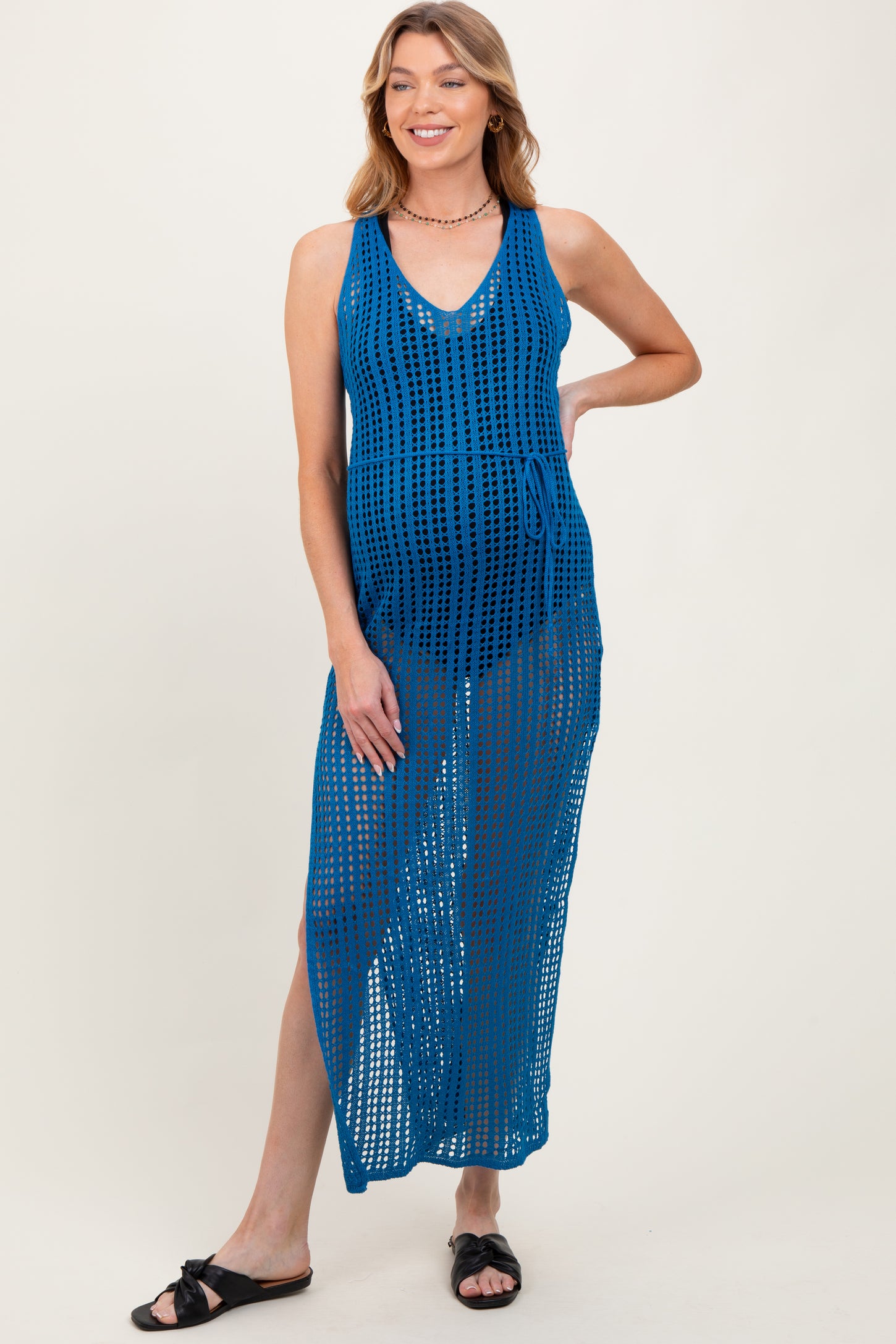 woman wearing a blue maternity cover-up dress with a v-neck and side tie, showcasing her baby bump