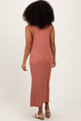 woman wearing a dusty rose sleeveless maxi dress with a fitted silhouette and a ribbed texture from the back