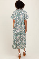 woman wearing a blue and white patterned midi dress with short sleeves and a gathered waist, viewed from the back