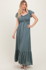 woman wearing a teal maxi dress with ruffled sleeves, smocked bodice, and front buttons