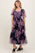 woman wearing a navy blue floral tiered maxi dress with short sheer sleeves and a square neckline