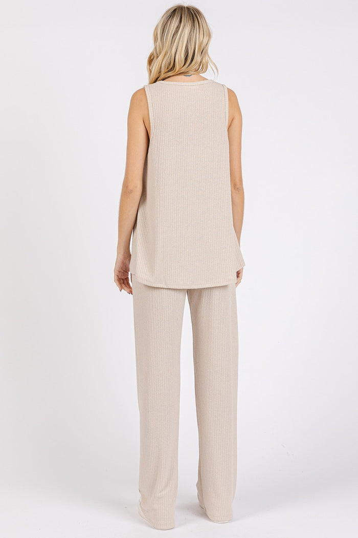 woman wearing a beige sleeveless top and matching wide-leg pants, seen from the back