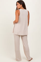 woman wearing a light beige maternity tank top with matching wide-leg pants, showing side view with a relaxed fit