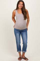 woman wearing a gray ribbed maternity tank top and blue rolled hem maternity jeans, showing her baby bump
