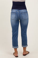 woman wearing a pair of cuffed light blue maternity jeans, viewed from the back