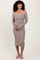 woman wearing a brown and white striped off-the-shoulder ribbed midi dress with long sleeves