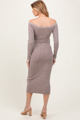 woman wearing a brown and white striped off-shoulder maternity dress, fitted style with long sleeves and mid-calf length