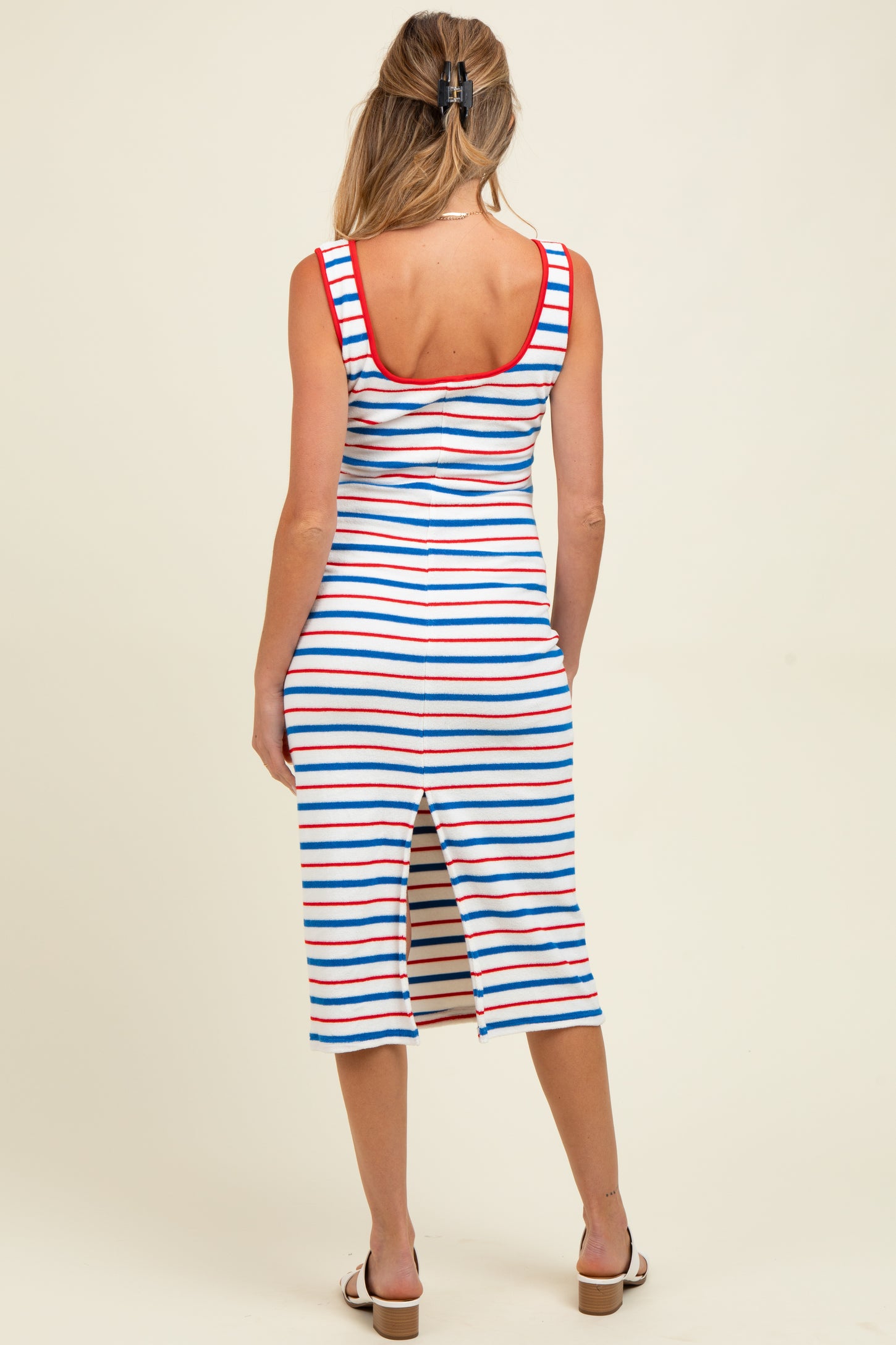 woman wearing a striped maternity dress with a scoop back and side slit