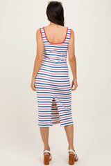 woman wearing a red, white, and blue striped midi dress with a back slit, standing against a neutral background