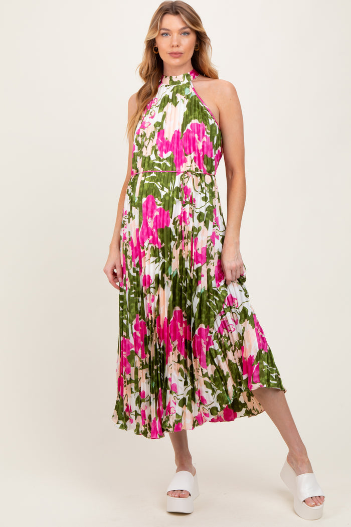 woman wearing a floral maternity dress with a halter neck and pleated design
