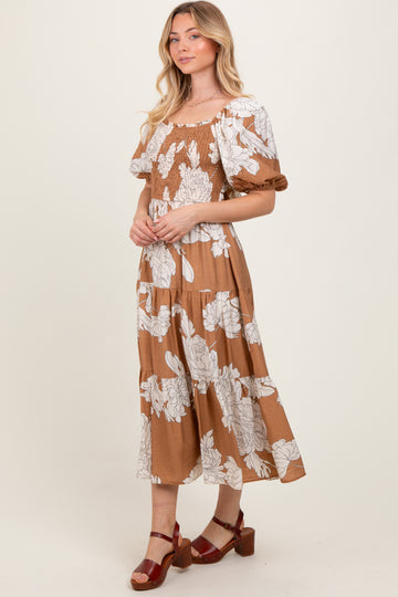 woman wearing a brown floral maxi dress with short puff sleeves and a smocked bodice