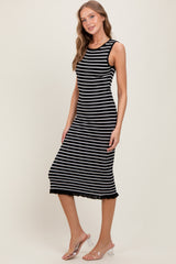woman wearing a black and white striped sleeveless midi dress with a lace hem detail